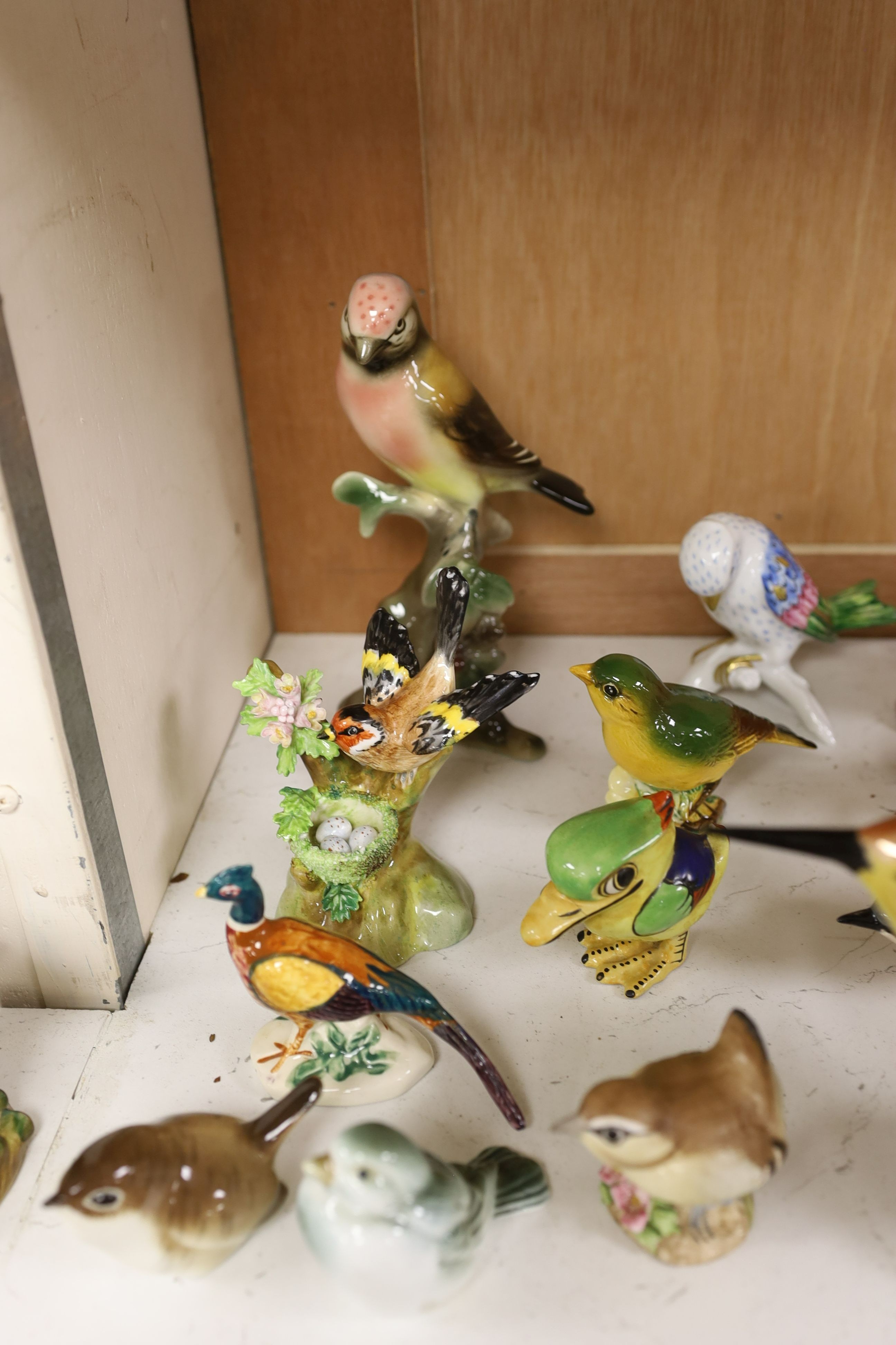 A large collection of ceramic bird figures including Beswick, Russian models, Karl Ens etc